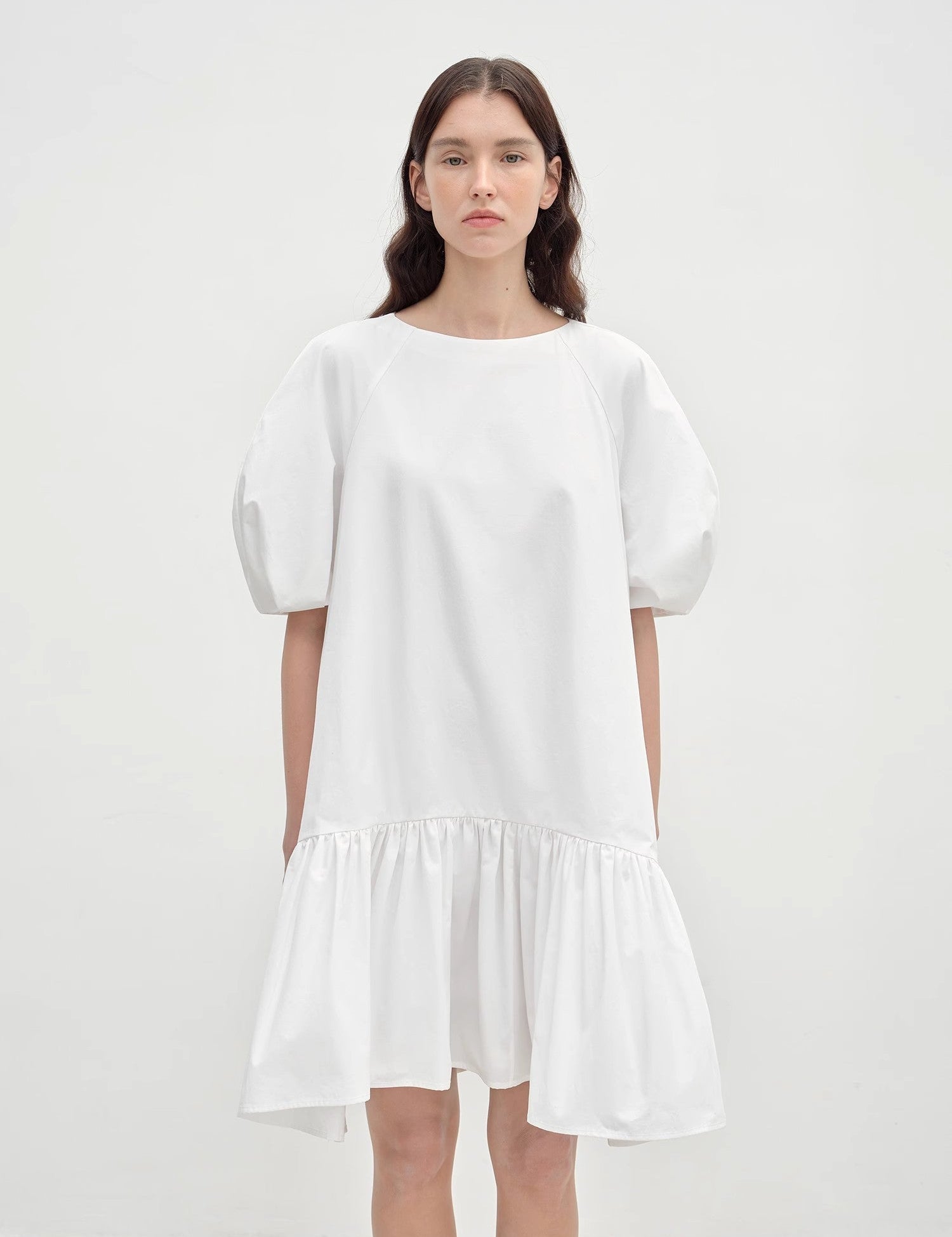 Model wearing Evaira Puff-Sleeve Cotton Dress with round neckline, sculpted sleeves, and dramatic gathered skirt in white.