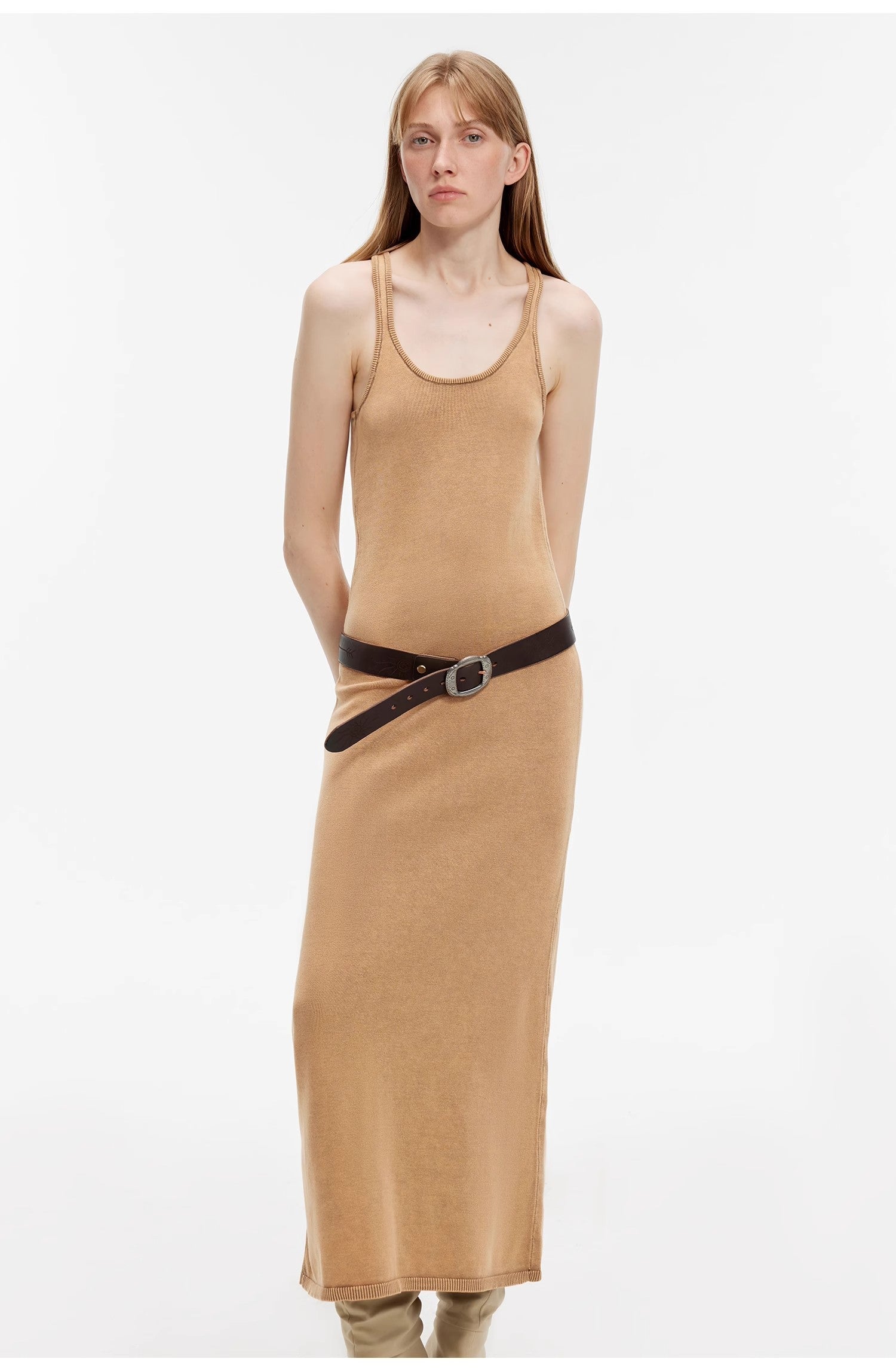 Woman wearing Feryn Enzyme-Washed Vest Dress, ankle-length in muted brown, with a straight U-neckline and side belt accent.