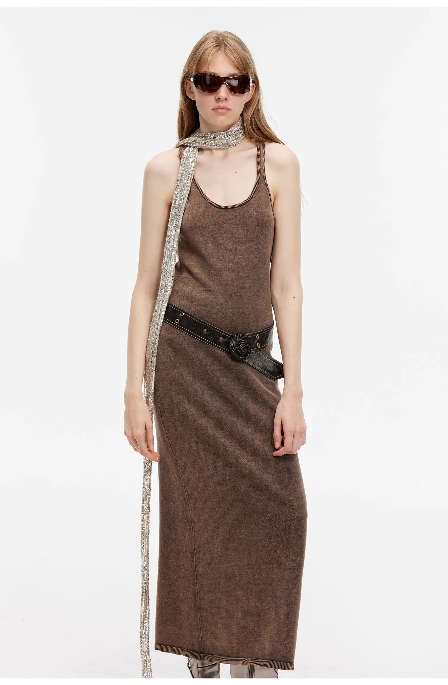 Model wearing Feryn Enzyme-Washed Vest Dress in brown with U-neckline and ergonomic side bindings, styled with a belt and scarf. 100% cotton.