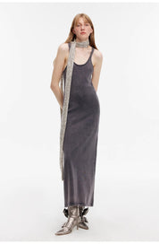 Feryn enzyme-washed cotton vest dress with U-neck, featuring a subtly distressed texture, worn by a model with a silver scarf.
