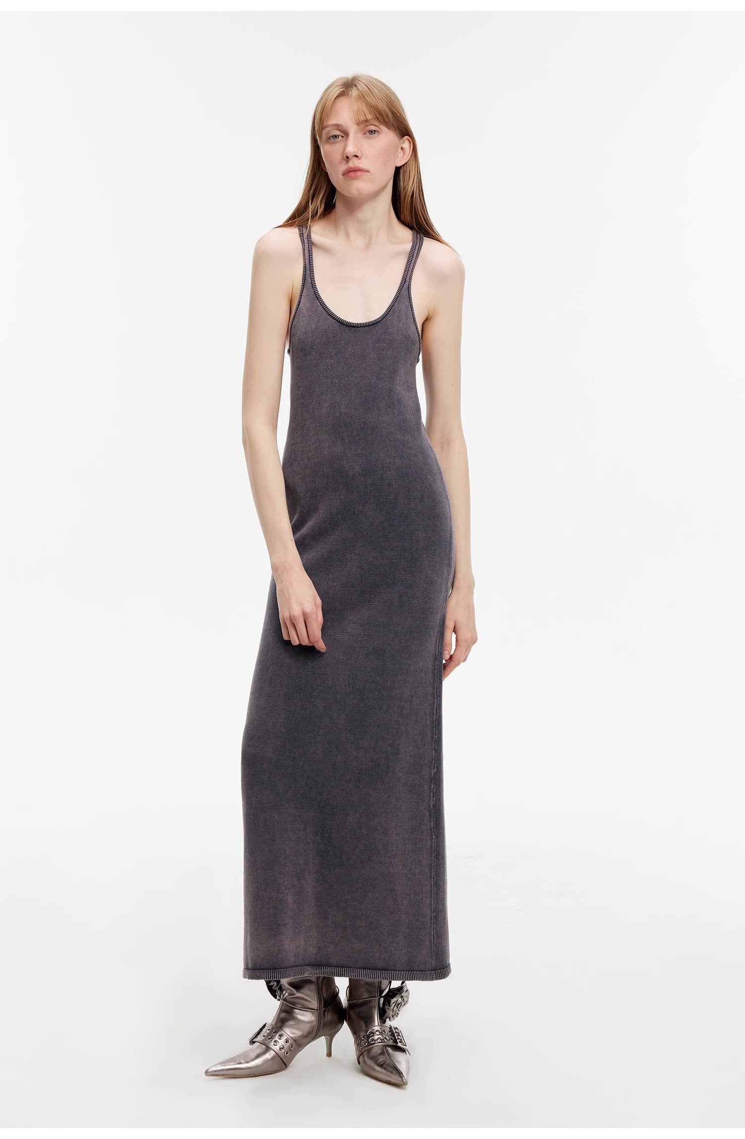 Woman wearing Feryn Enzyme-Washed Vest Dress with a U-neckline, ergonomic side bindings, and distressed texture.