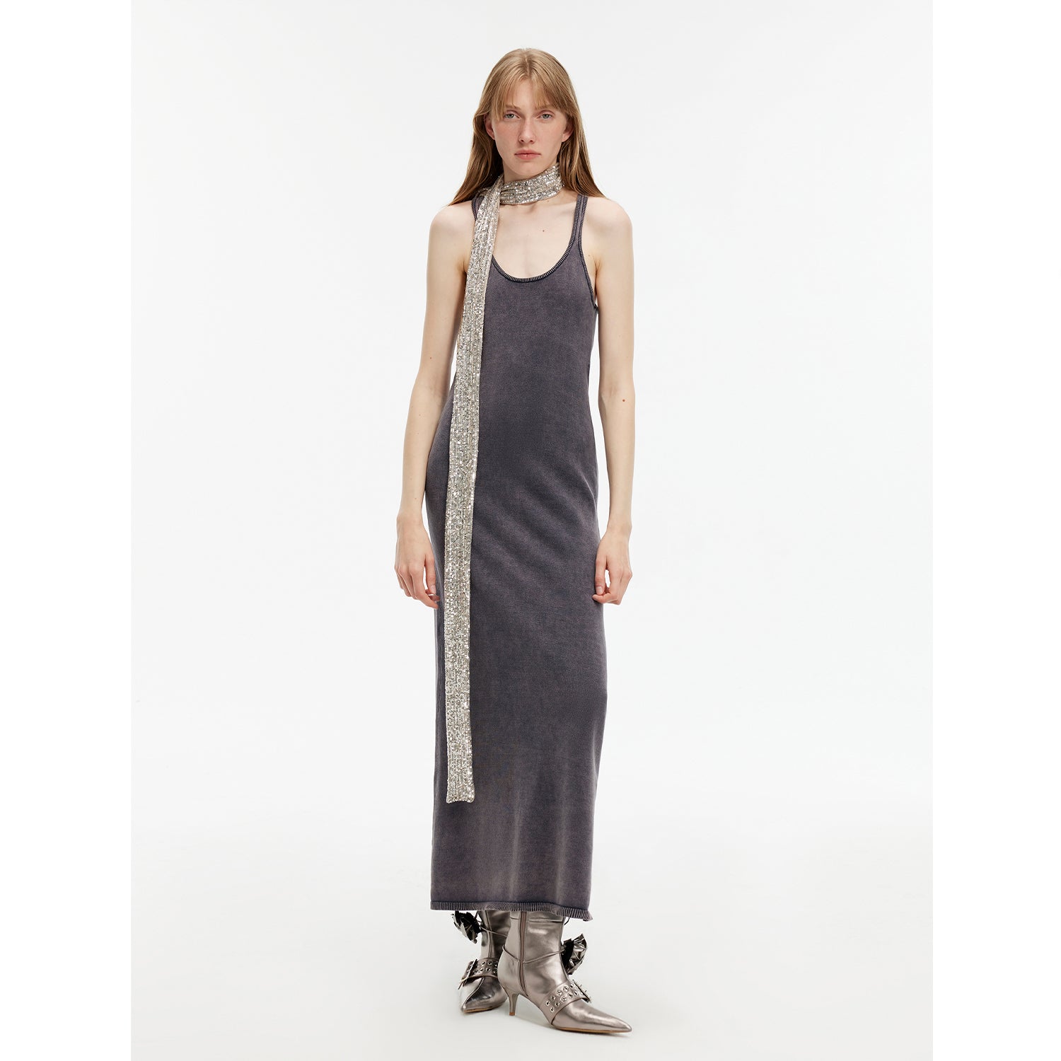 Woman wearing Feryn Enzyme-Washed Vest Dress in dark cotton with metallic scarf, highlighting U-neck and ergonomic side bindings.