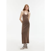 Woman wearing Feryn Enzyme-Washed Vest Dress with U-neckline, made from 100% combed cotton in a muted brown tone.