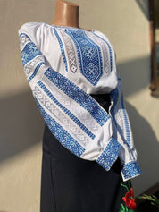 Galician cotton vyshyvanka with blue folk embroidery on a mannequin, showcasing traditional Ukrainian craft and design.