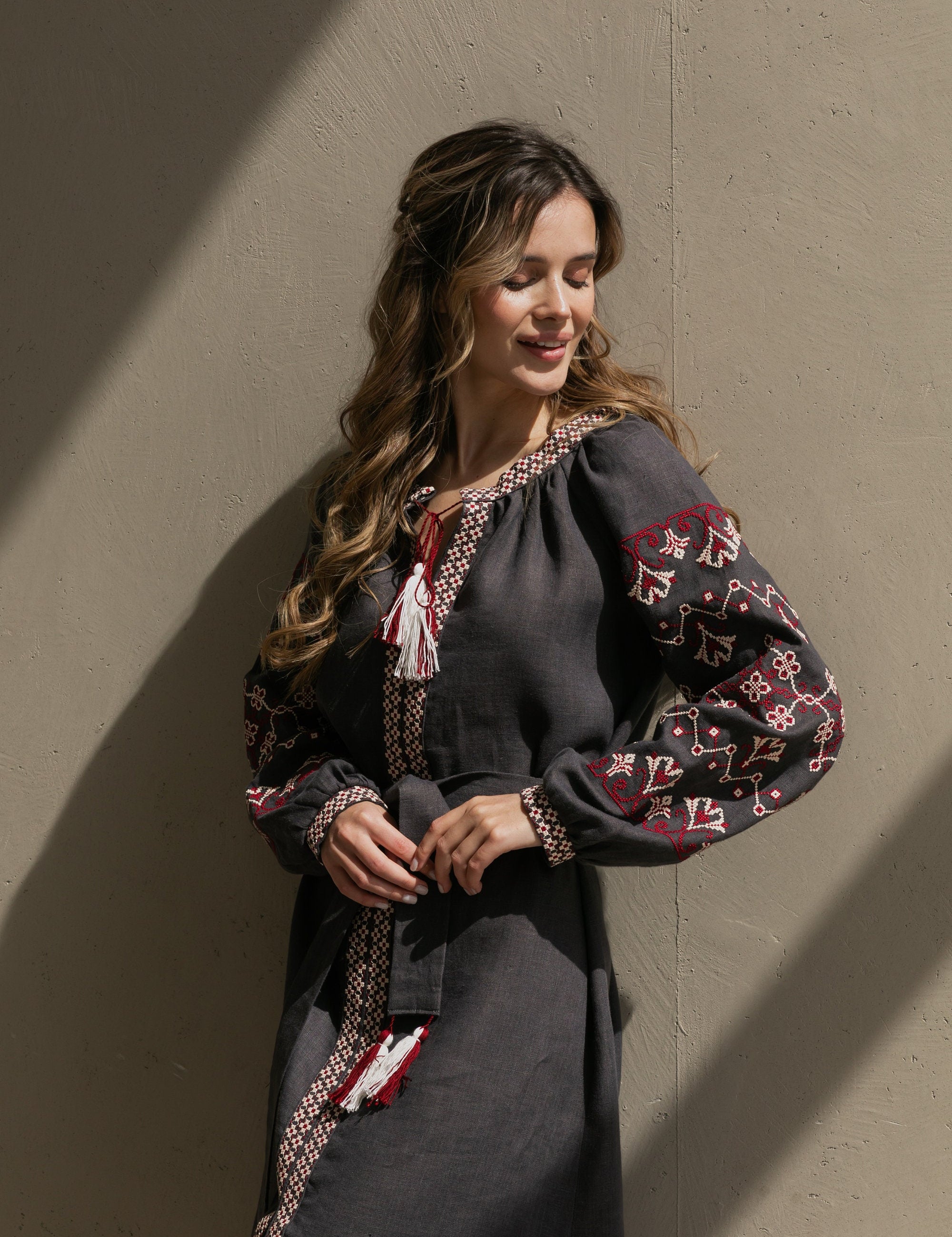 Woman wearing a gray linen Vyshyvanka dress with colorful embroidery, capturing Ukrainian boho folk style.