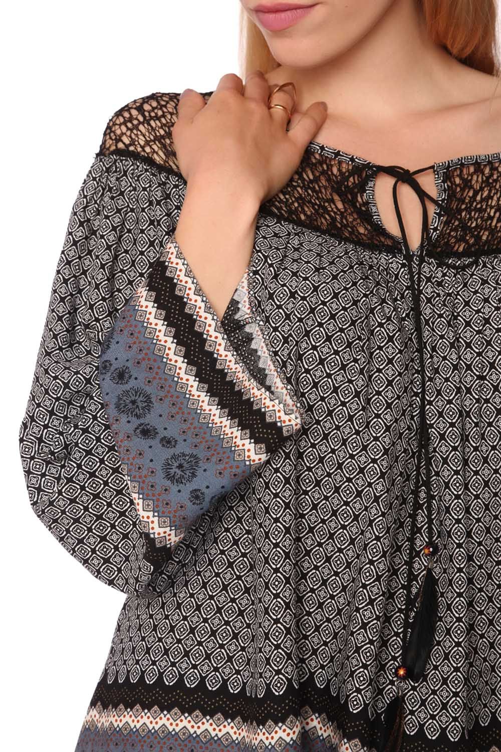 Model wearing Elvarae Paisley Cage Blouse with intricate gray paisley print and open cage neckline, showcasing bohemian and modern style.