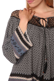 Model wearing Elvarae Paisley Cage Blouse with intricate gray paisley print and open cage neckline, showcasing bohemian and modern style.
