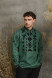 Man wearing a green linen embroidered Ukrainian vyshyvanka shirt, perfect for cultural celebrations and festive events.