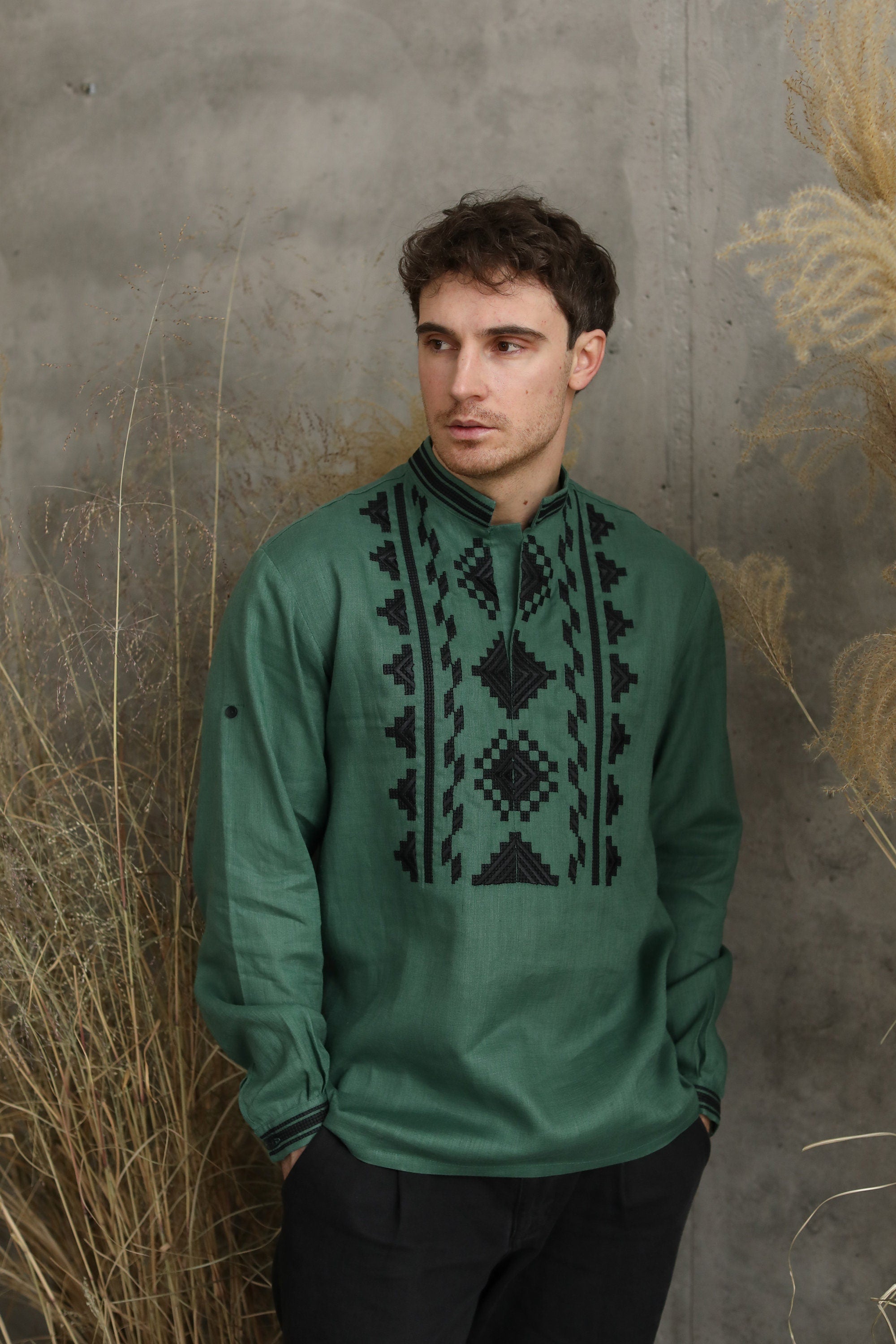 Man wearing a green linen embroidered Ukrainian vyshyvanka shirt, perfect for cultural celebrations and festive events.