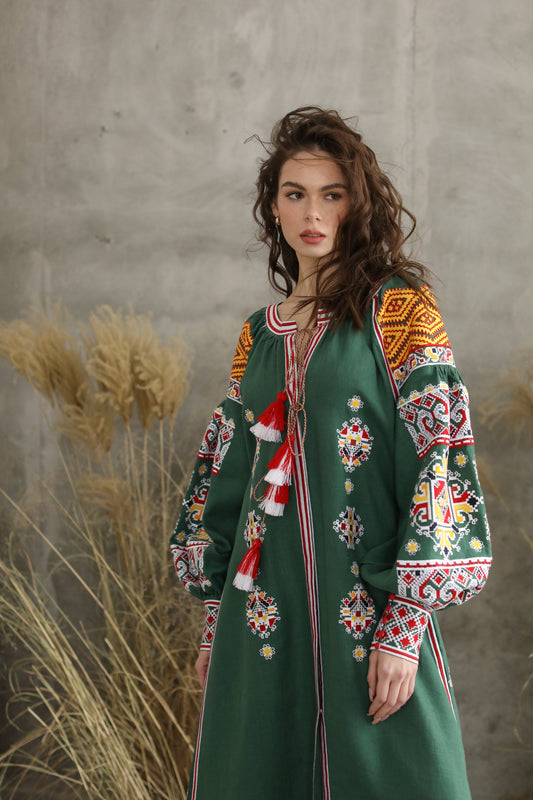 Woman wearing a green embroidered Ukrainian Vyshyvanka dress, ideal for weddings, holidays, or special occasions.