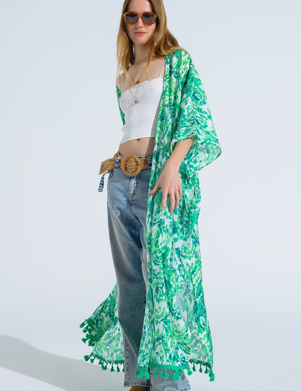 4 sleeves, and fringe trim, styled over casual outfit.