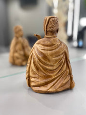 Hand-carved wooden bandurist figurine symbolizing Ukrainian culture, made from linden wood, highlighting traditional craftsmanship.