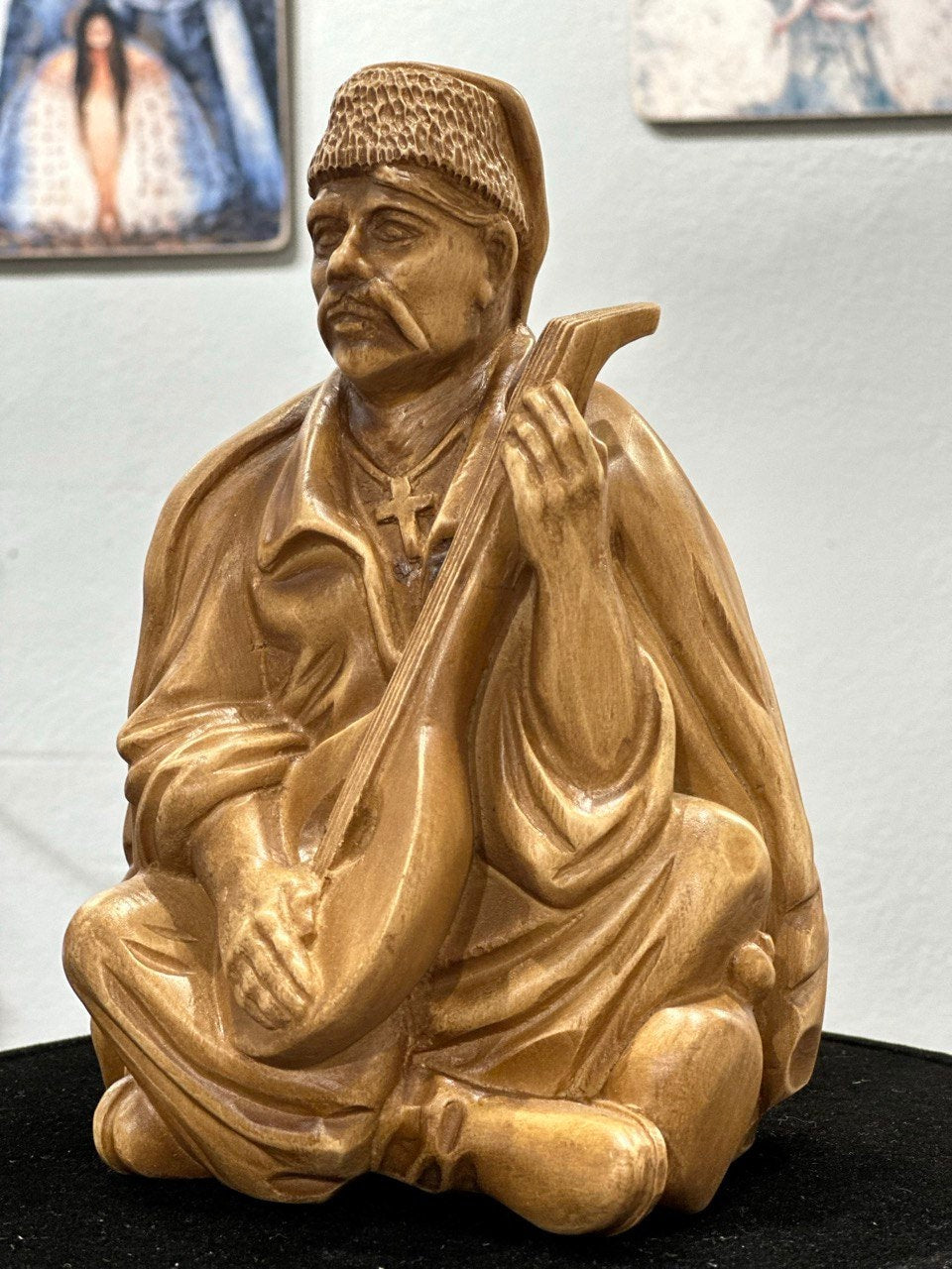 Hand-carved wooden bandurist figurine showcasing Ukrainian cultural art, made from natural linden wood.