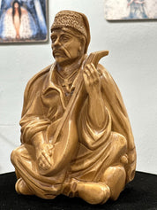 Hand-carved wooden bandurist figurine showcasing Ukrainian cultural art, made from natural linden wood.
