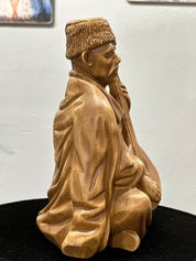 Hand-carved wooden bandurist figurine made from linden wood, depicting a Ukrainian musician playing the bandura, symbolizing heritage.