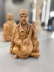 Hand-carved wooden bandurist figurine made from linden wood, showcasing traditional Ukrainian craftsmanship and culture.