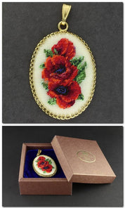 Hand-embroidered pendant necklace with floral miniature on silk, showcasing Petit Point technique in a gift box.