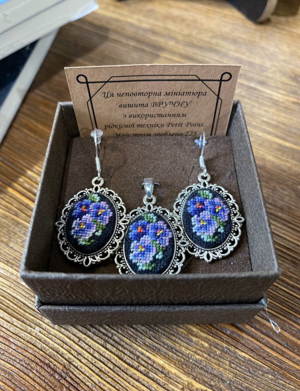 Hand-embroidered jewelry set with floral Petit Point silk pendant and earrings, showcasing Ukrainian craftsmanship in a gift box.