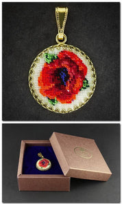 Hand-embroidered floral pendant necklace in box, featuring Petit Point silk embroidery with red and green floral design.