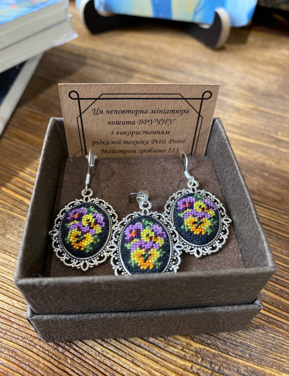Hand-embroidered Petit Point silk jewelry set with floral design, including a pendant and earrings, in a decorative gift box.