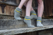 Hand-knitted grey woolen socks with blue and yellow Ukrainian flag accents, 100% natural wool, cozy winter wear.