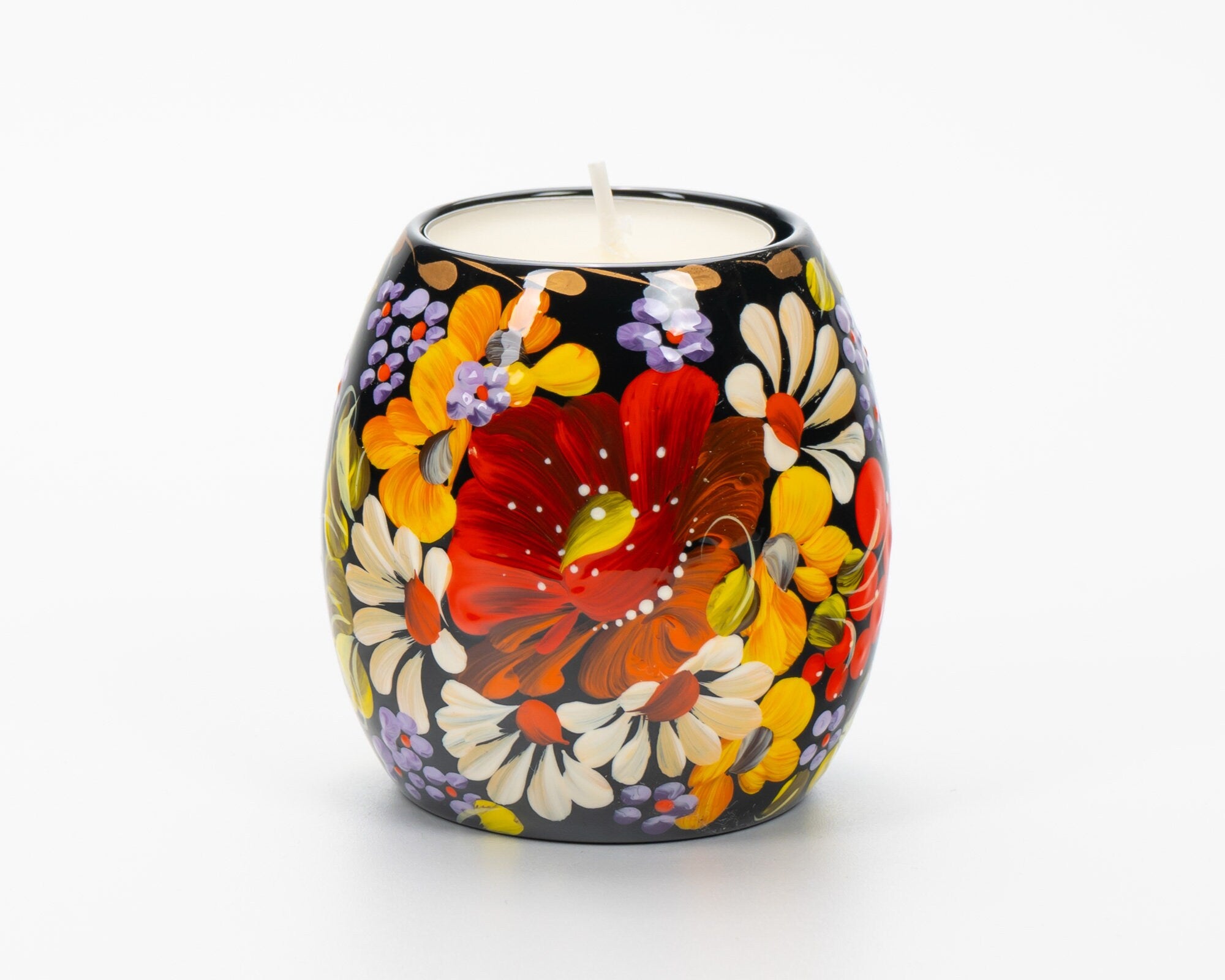 Hand painted Ukrainian tea light candle holder with Petrykivka floral design, showcasing vibrant red, yellow, and white flowers.