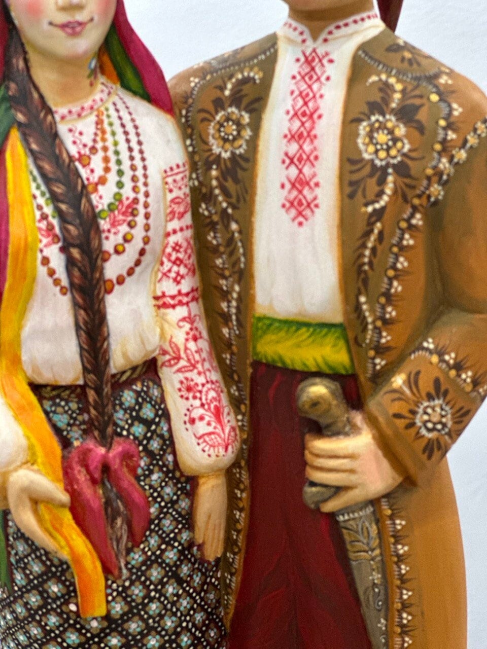Hand-painted wooden couple figurine showcasing Ukrainian folk artistry, ideal as a wedding or 5th anniversary gift, 35 cm tall.