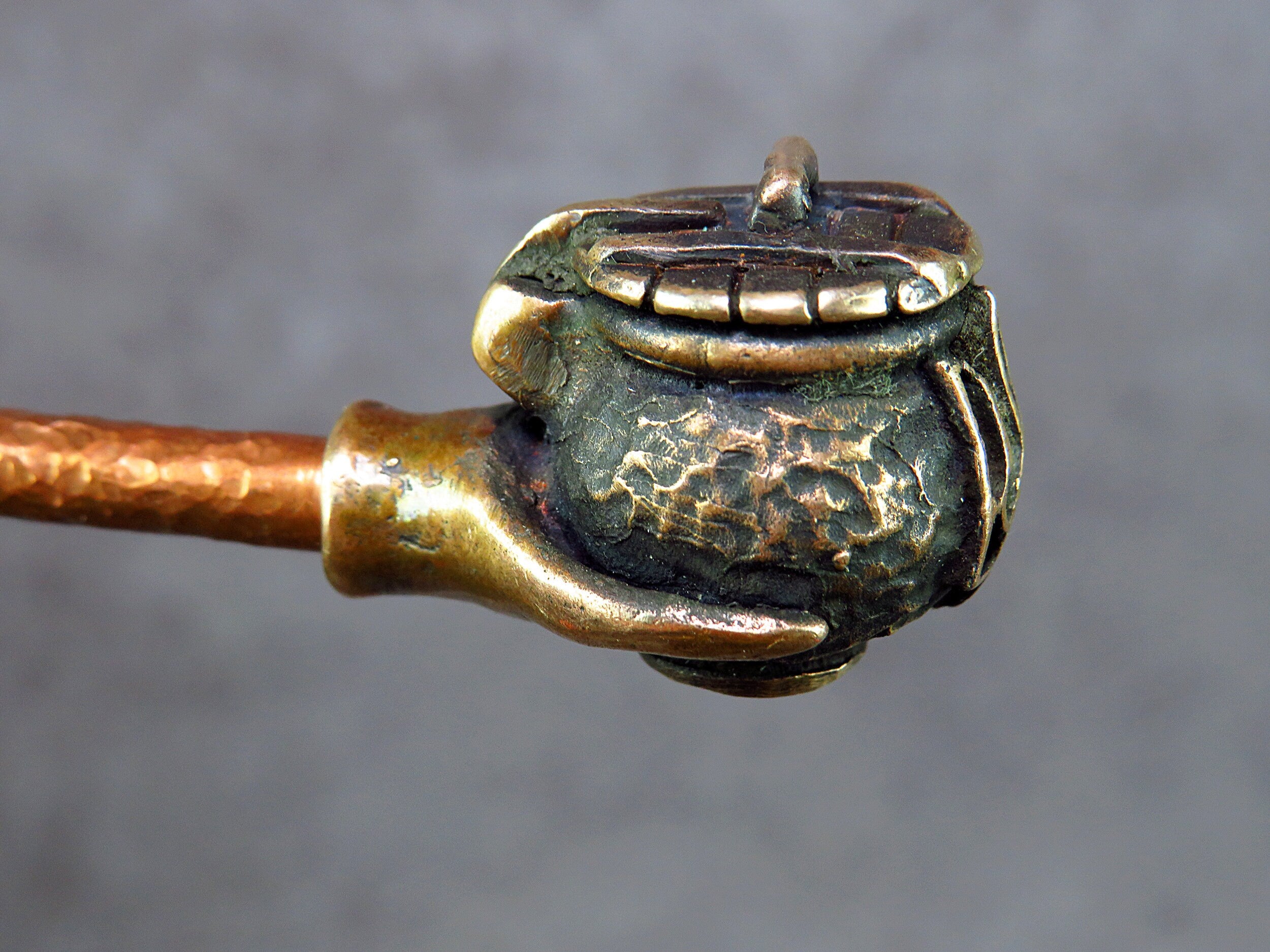 Handcrafted bronze pipe with Ukrainian trident, featuring unique artisan details and cultural symbolism.