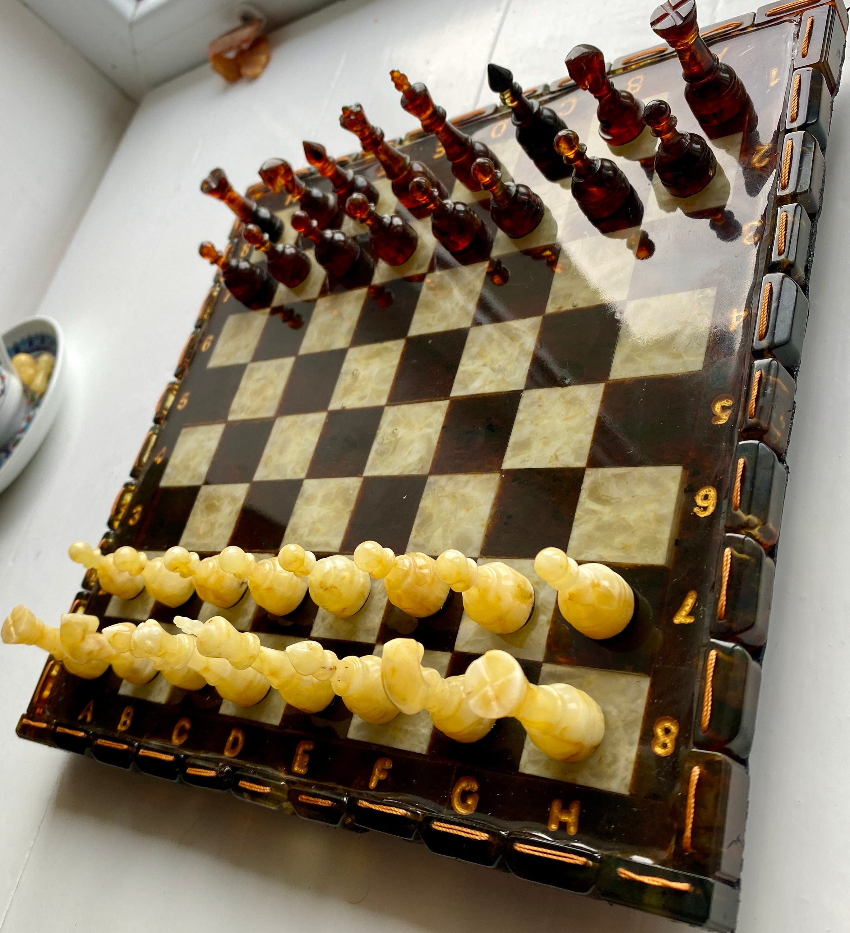 Luxurious handcrafted Baltic amber chess set with elegant inlaid board, perfect for collectors and enthusiasts.