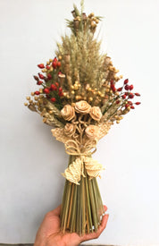 Handcrafted Ukrainian Didukh Christmas decoration with wheat sheaf and dried flowers, symbolizing Ukrainian tradition and prosperity.