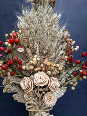 Handcrafted Ukrainian Didukh Christmas decoration with wheat sheaf and dried flowers, symbolizing tradition and prosperity.