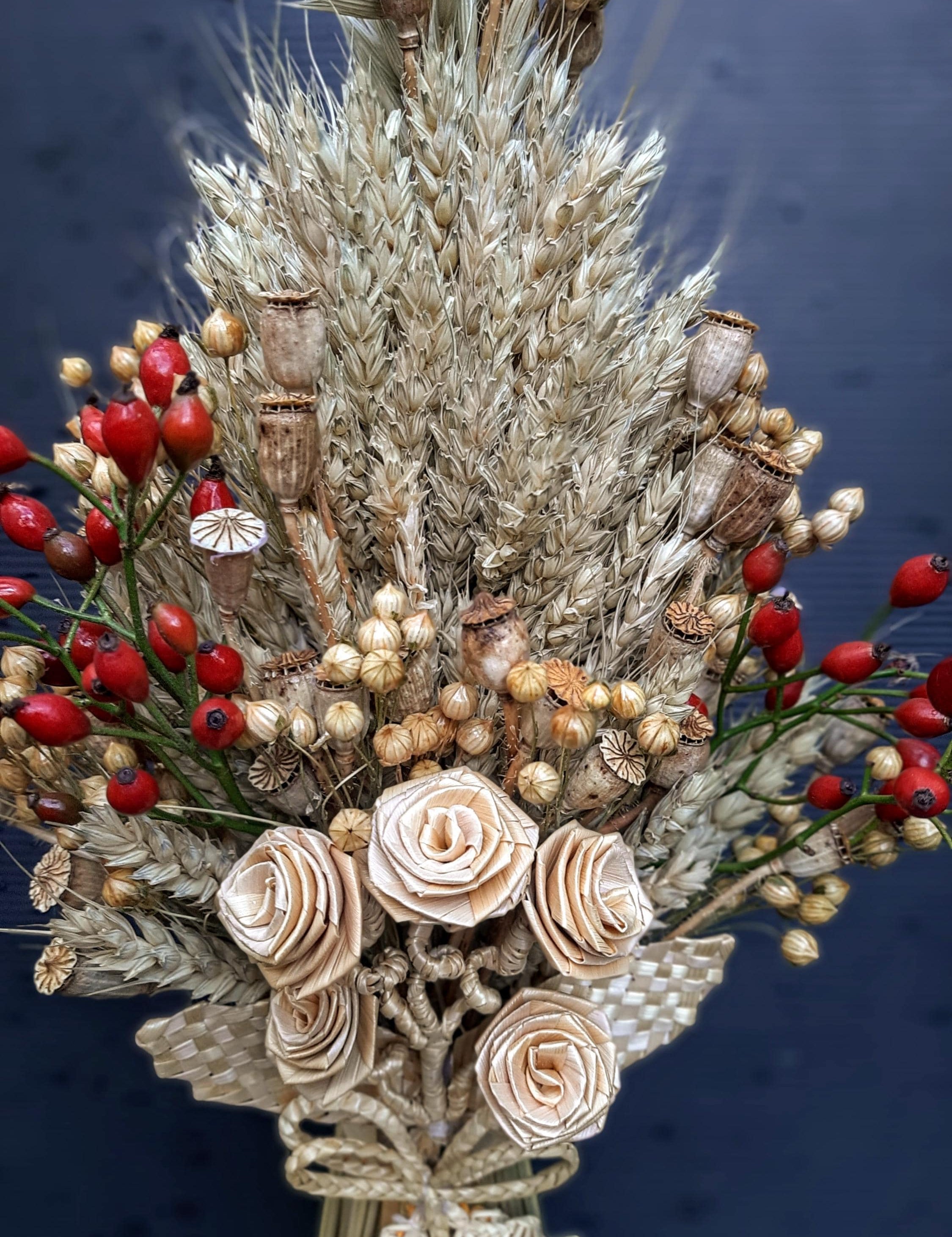 Handcrafted Ukrainian Didukh Christmas decoration with wheat sheaf and dried flowers, symbolizing tradition and prosperity.