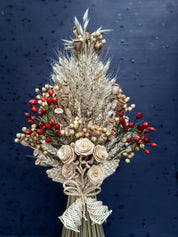 Handcrafted Ukrainian Didukh with wheat sheaf and dried flowers, Christmas decoration symbolizing tradition and prosperity.