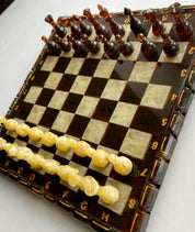 Luxurious handcrafted Baltic amber chess set with a beautifully inlaid board, perfect for collectors and chess enthusiasts. ♟️
