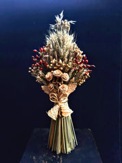 Handcrafted Ukrainian Didukh Christmas decoration with wheat sheaf and dried flowers, symbolizing tradition and prosperity.
