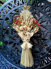Handcrafted Ukrainian Didukh Christmas decoration made of wheat sheaf and dried flowers, symbolizing tradition and prosperity.