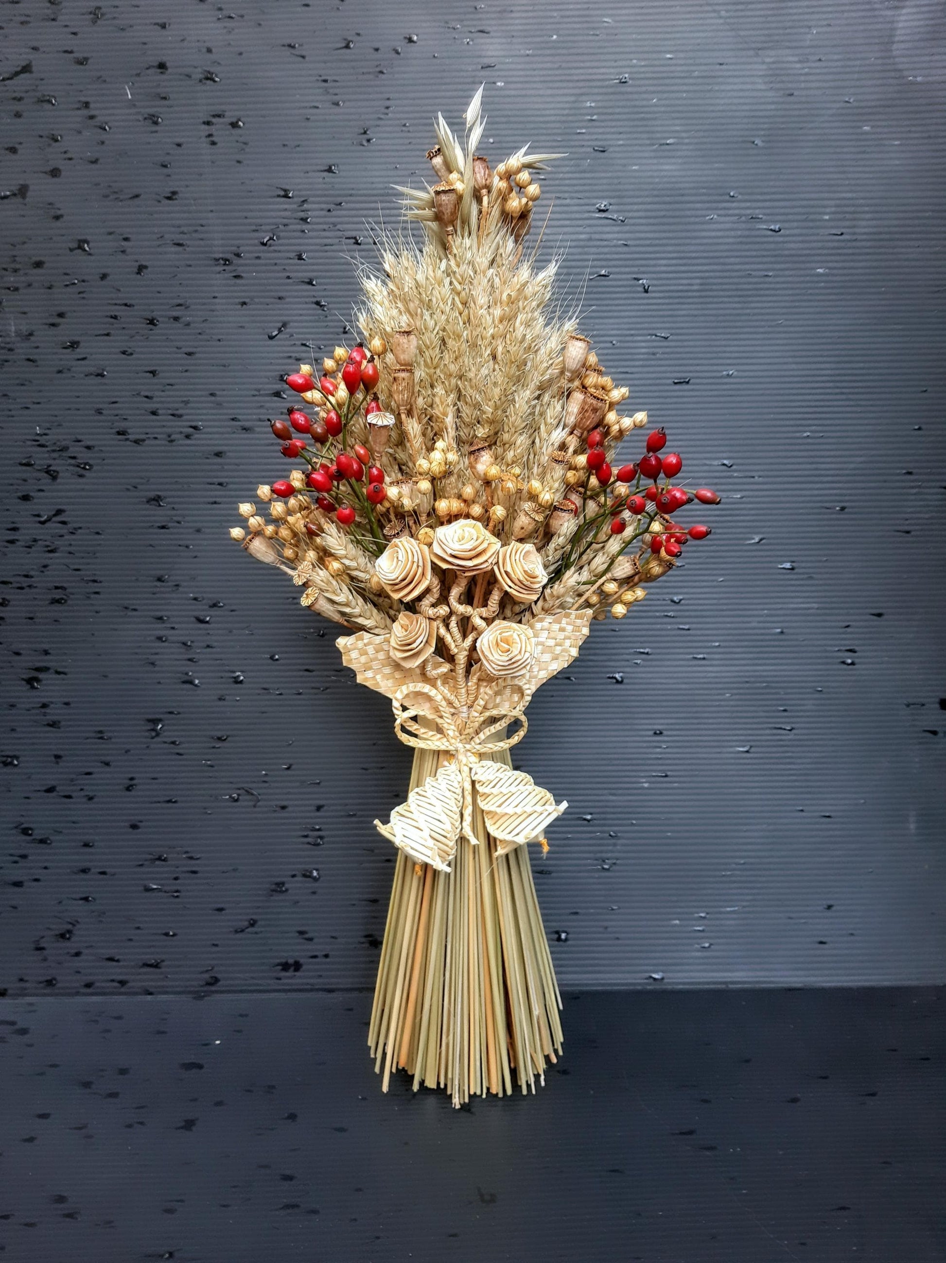 Handcrafted Ukrainian Didukh with wheat and dried flowers, a traditional Christmas decoration symbolizing fertility and prosperity.