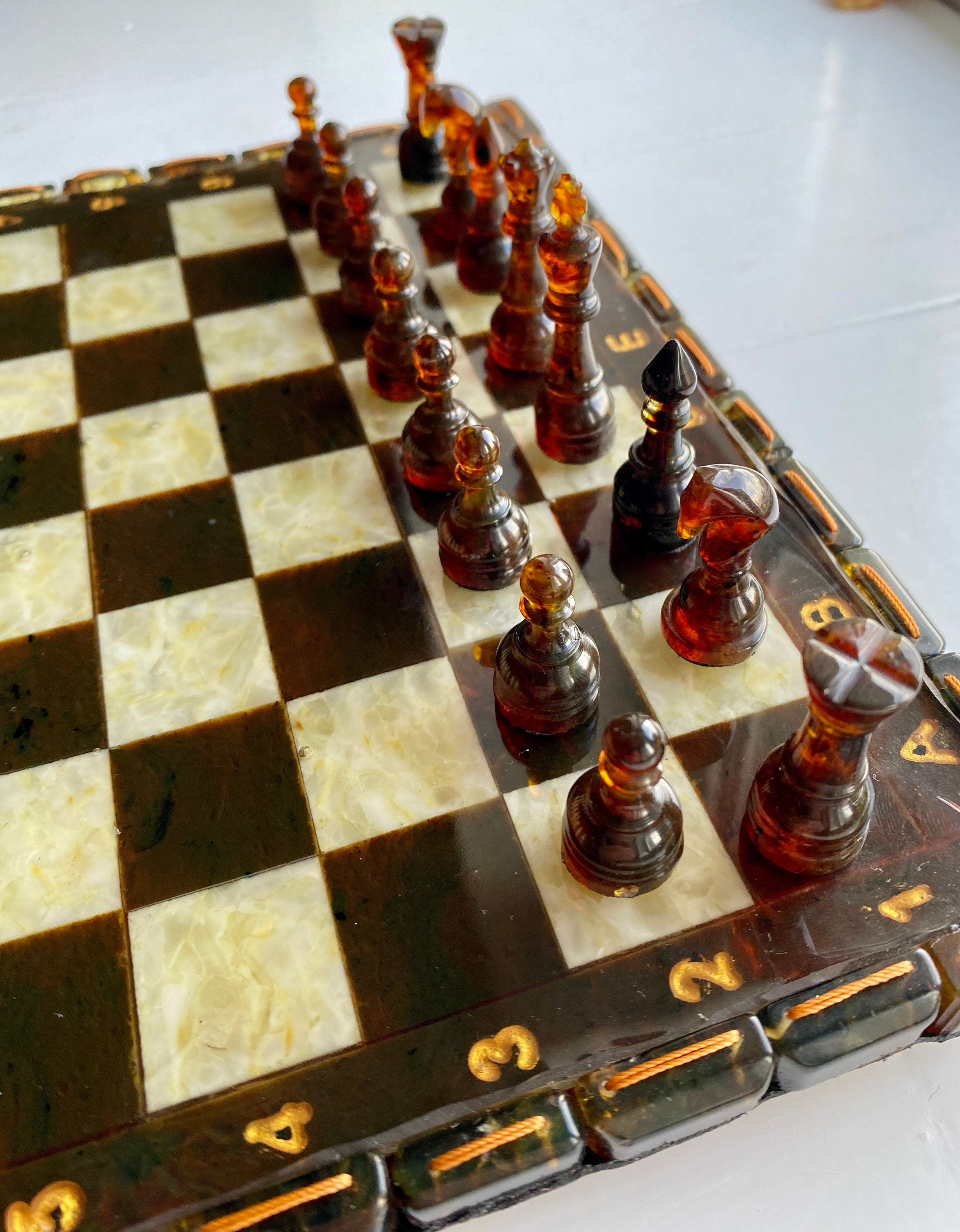 Handcrafted Baltic amber chess set with elegant board and amber-inlaid pieces, perfect for collectors and chess enthusiasts.