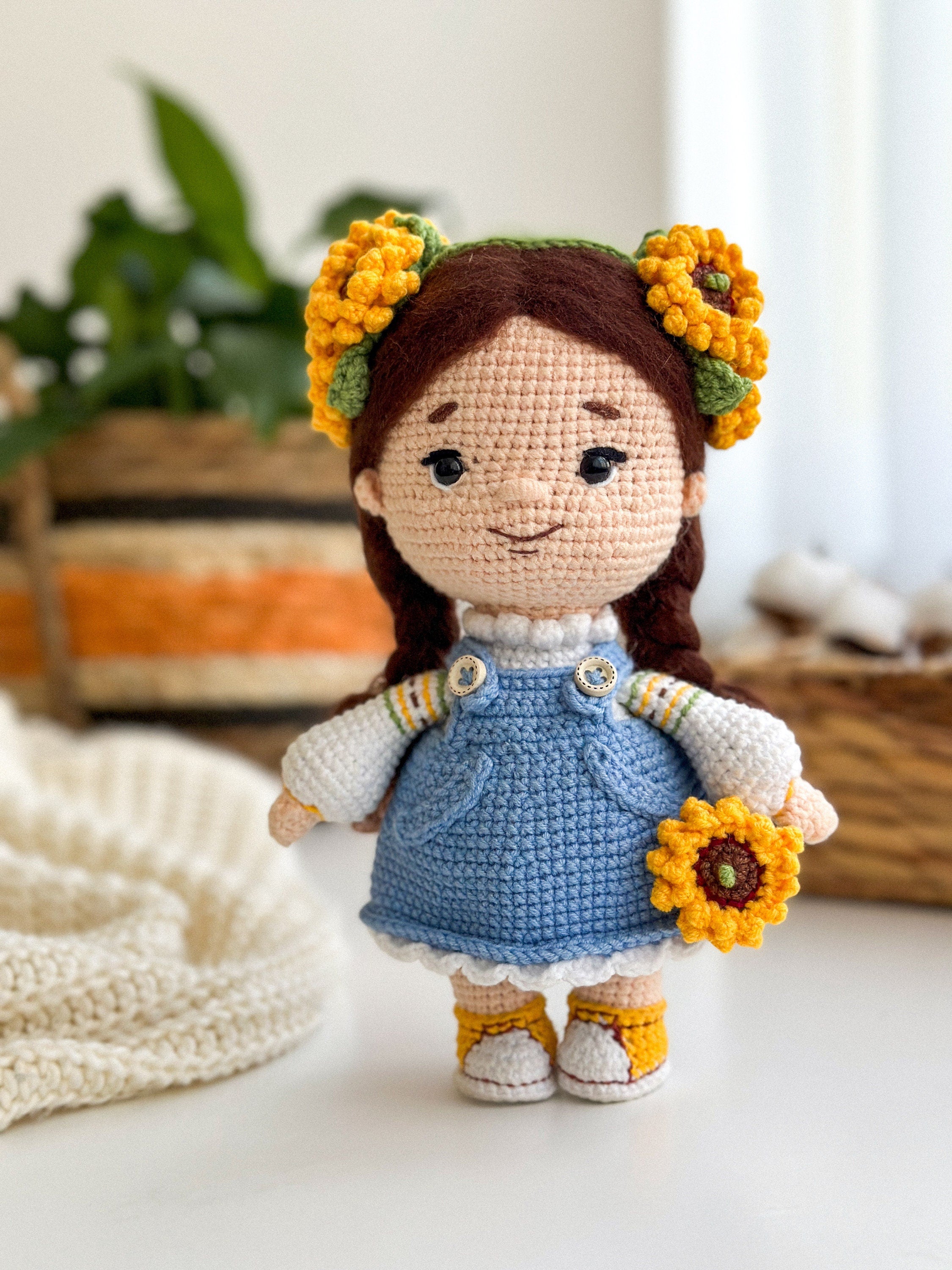 Handmade knitted Ukrainian themed doll with sunflower accents, blue dress, and intricate details, perfect for gifting or collecting.
