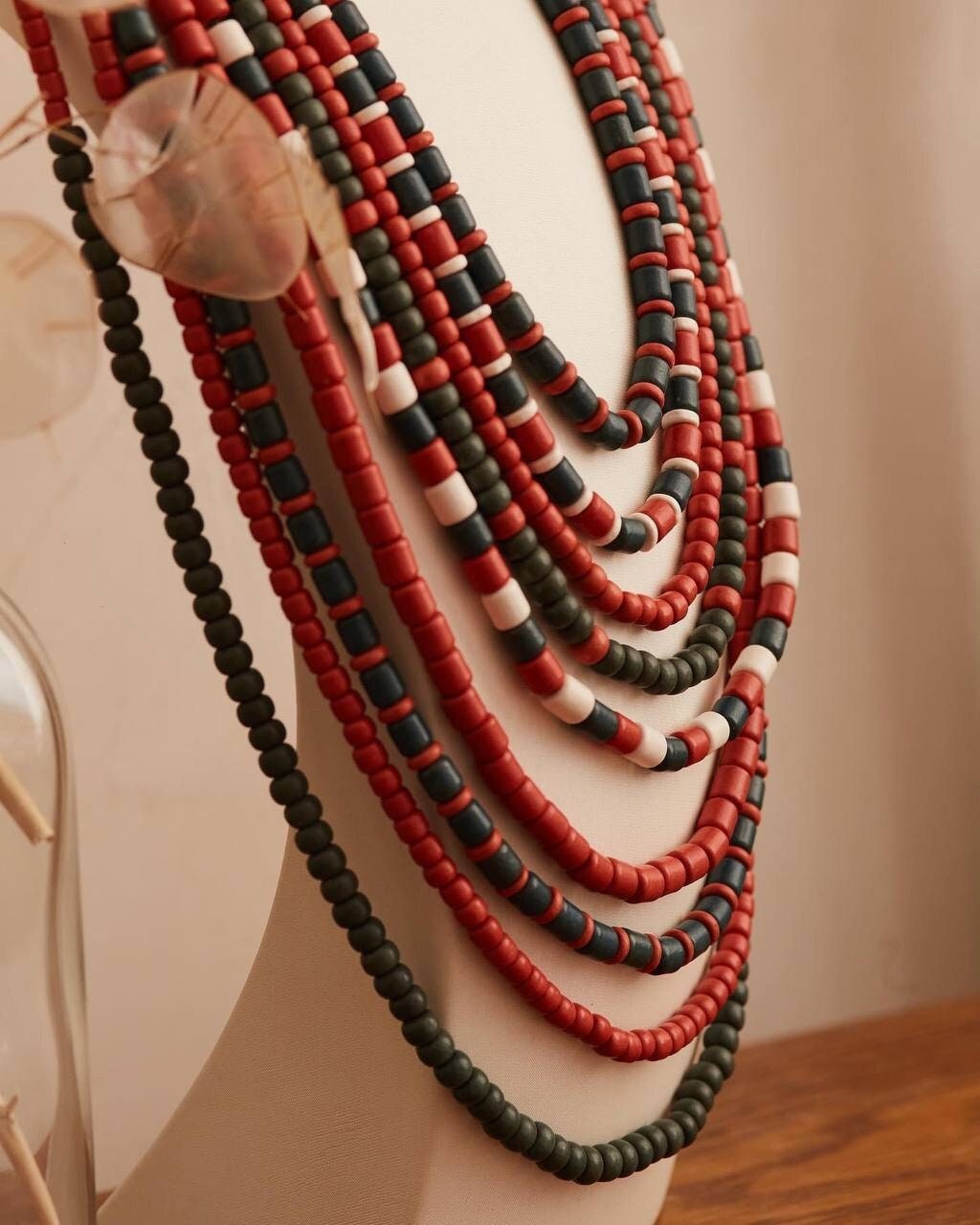 Handmade Ukrainian red and green ceramic beaded necklace on display stand, traditional ethnic jewelry gift for her.