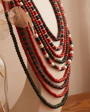 Handmade Ukrainian red and green ceramic beaded necklace on display stand, traditional ethnic jewelry gift for her.