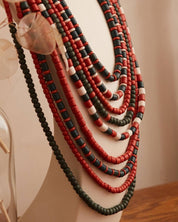 Handmade red and green Ukrainian ceramic necklace displayed on mannequin, traditional ethnic jewelry, ideal gift for her or Easter.