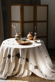 Handmade Ukrainian embroidered tablecloth with ethnic designs, 300x150 cm, on a table with pottery, perfect Easter gift or decor.
