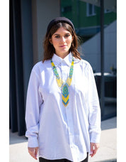 Woman wearing 2025 handmade Ukrainian gerdan necklace in blue and yellow, showcasing beaded folk jewelry style.