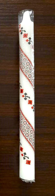 Handmade Ukrainian 10" taper candle with red and green festive design on a wooden background.