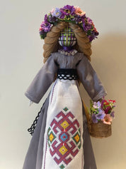 Handmade Bereginya Motanka Doll on Wooden Stand, adorned with flowers, symbol of Ukrainian protection and prosperity.