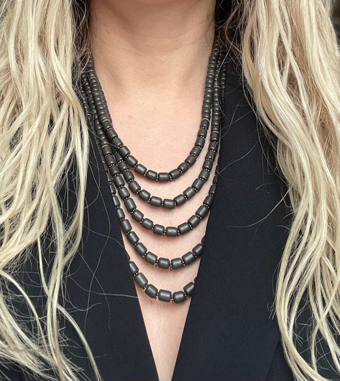 Black ceramic Ukrainian necklace with Hutsul ethnic design, worn by model, showcasing elegant handmade beads.