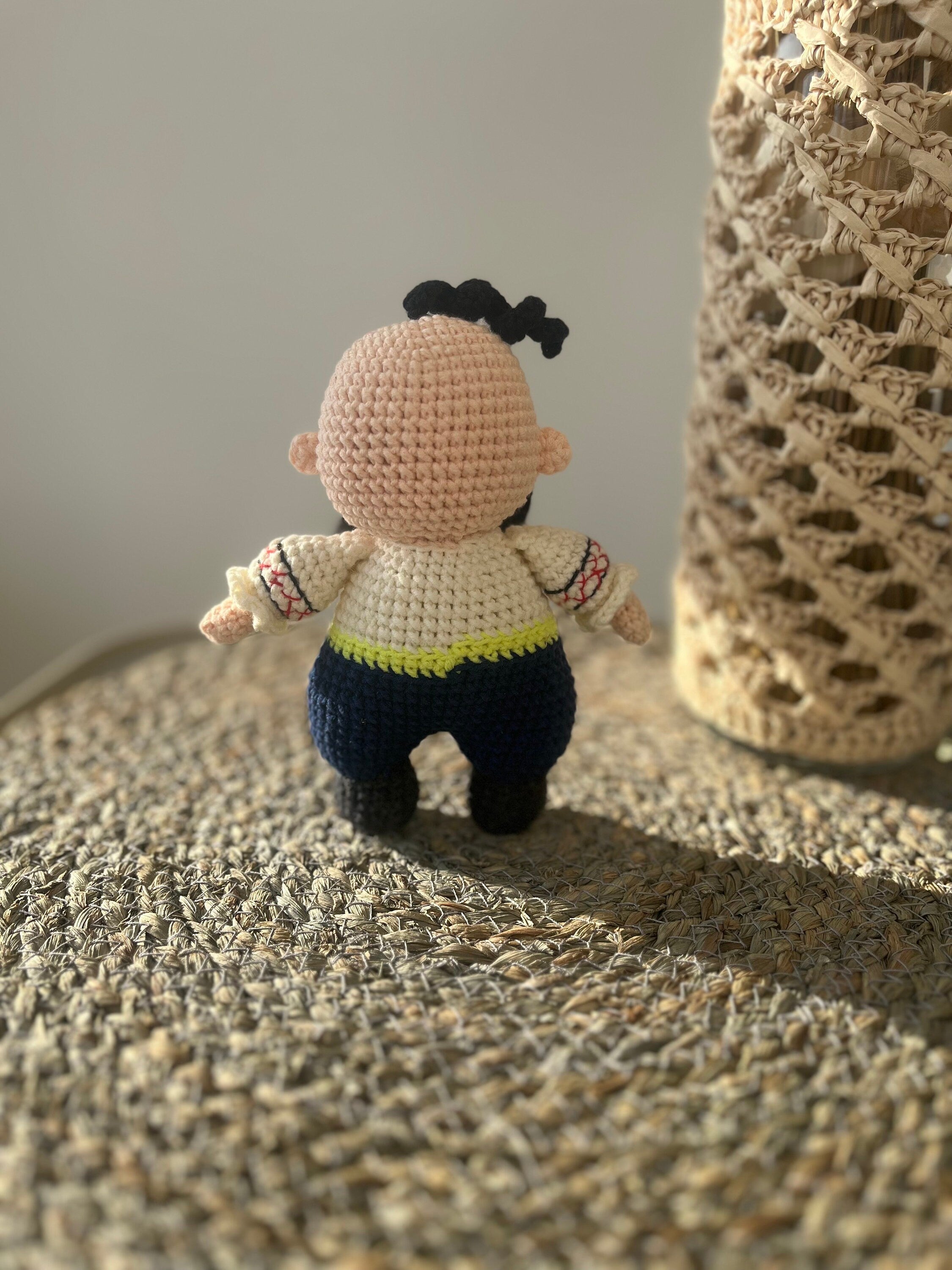 Handmade crochet Cossack doll, Ukrainian folk art, ethnic home decor, unique gift, displayed on woven surface.