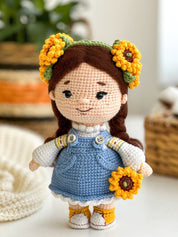 Handmade knitted doll with sunflowers, Ukrainian themed toy, soft and cozy gift, wearing blue dress and yellow accents