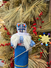 Handmade Ukrainian Motanka Doll 'Christmas' on wooden stand, symbolizing home protection and festive spirit.